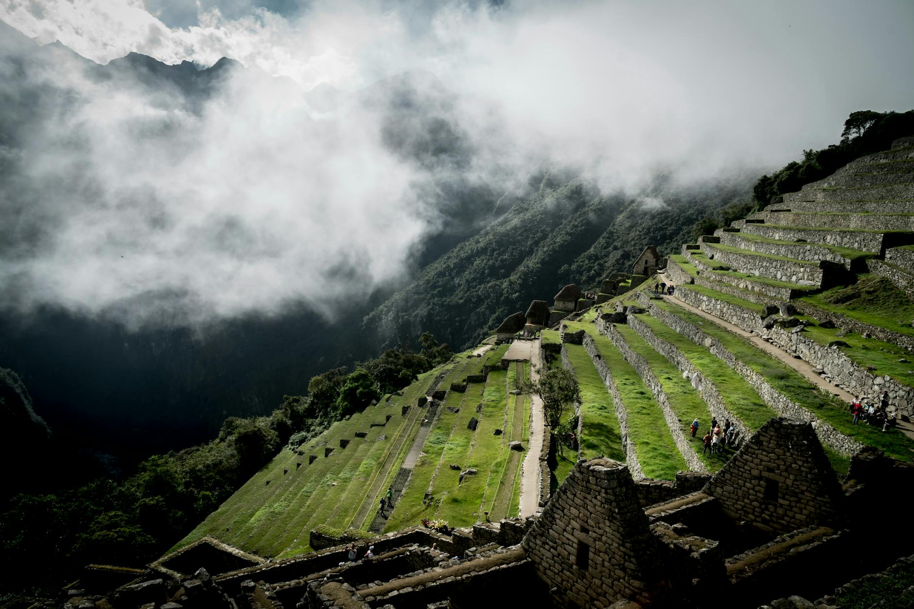 tourists on terraced fields in the lost city of the incas