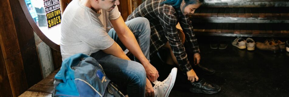 young diverse couple of travellers taking off shoes