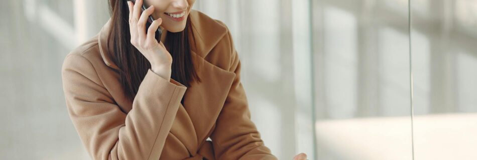 charming woman talking on smartphone in airport