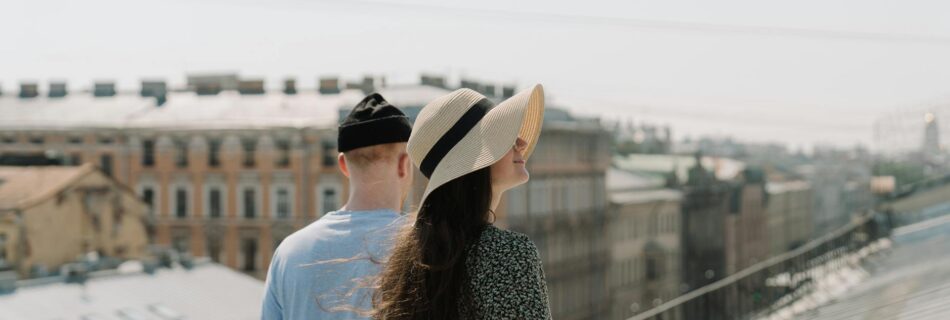 woman in white shirt and black and white polka dot skirt wearing white hat standing on near near near near