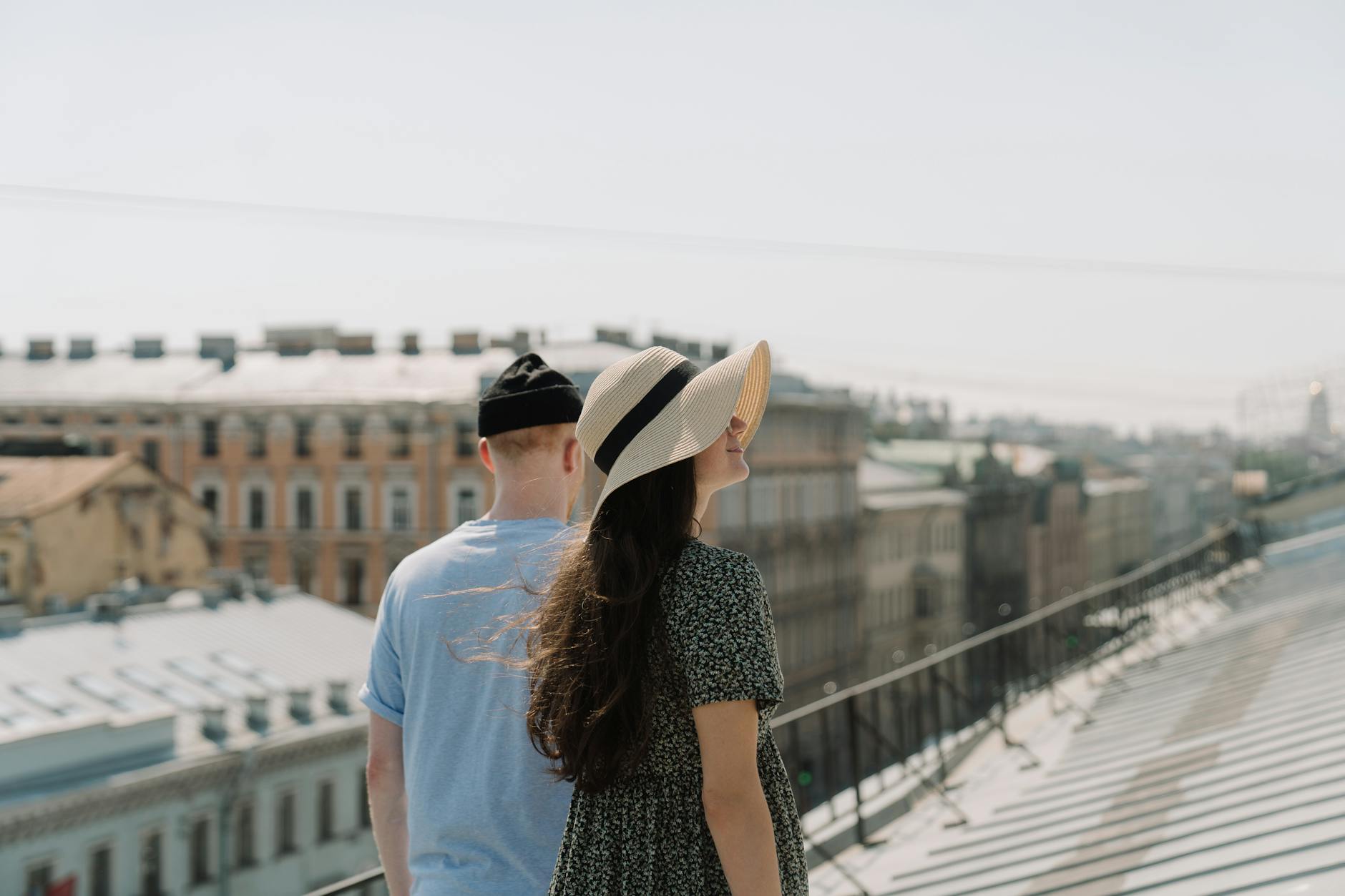 woman in white shirt and black and white polka dot skirt wearing white hat standing on near near near near