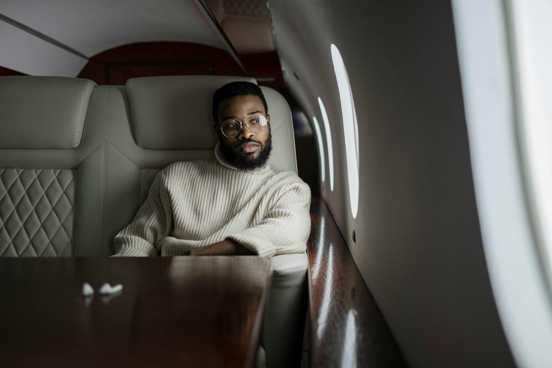 a man glancing out the airplane window