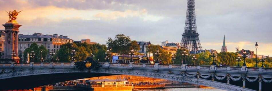 view of a bridge in paris at sunset
