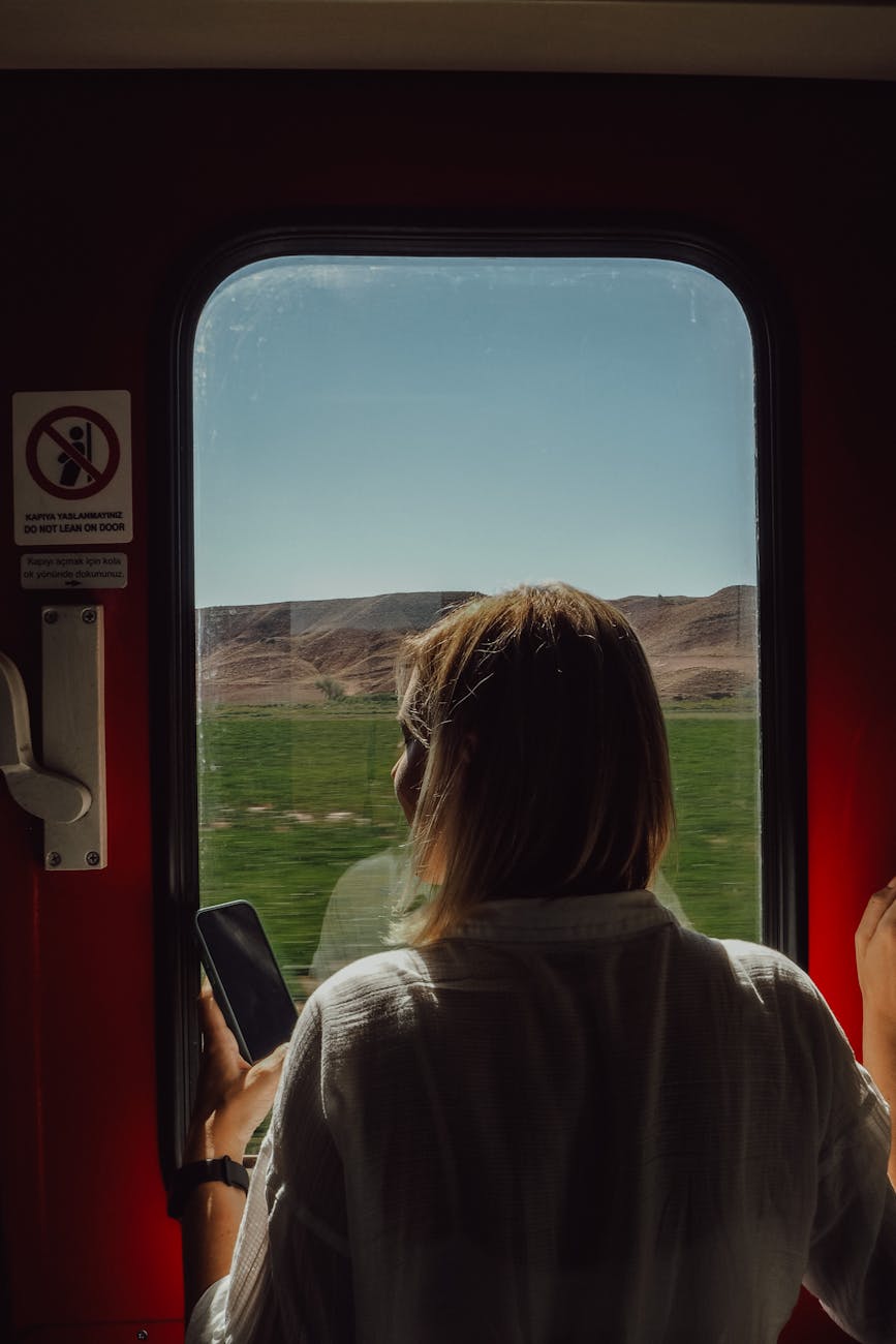 woman looking through the window in a train