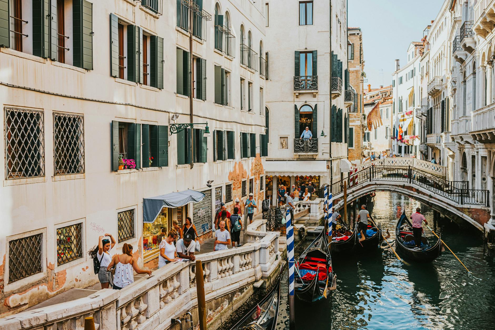 crowd walking along a canal in venice italy