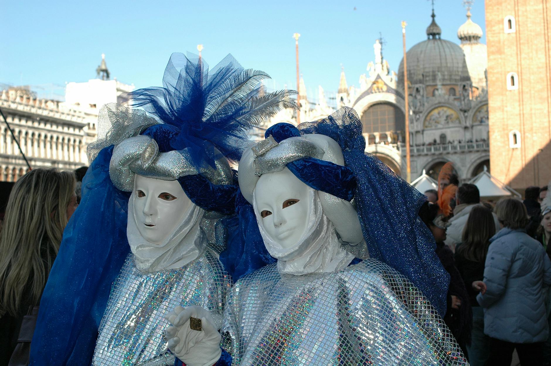 venetian carnival participants in traditional masked costumes