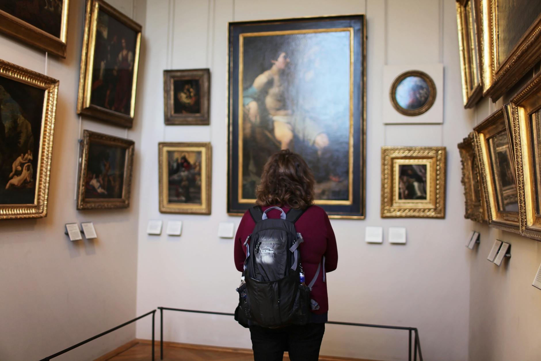woman standing in front of paintings