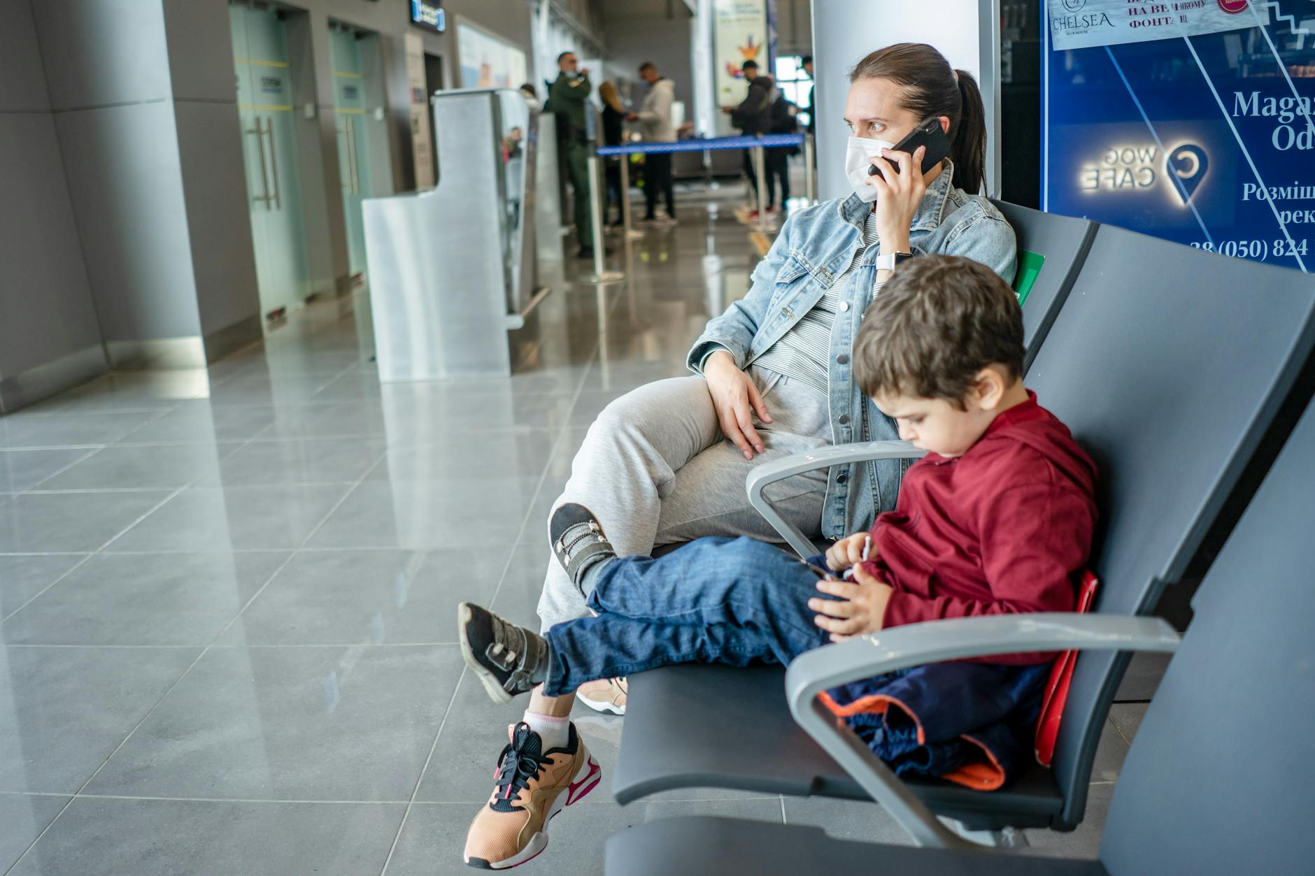 mother and son waiting at the airport
