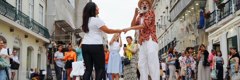 man and woman dancing in performance in alley in town