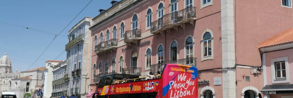 vibrant lisbon tour bus on historic street