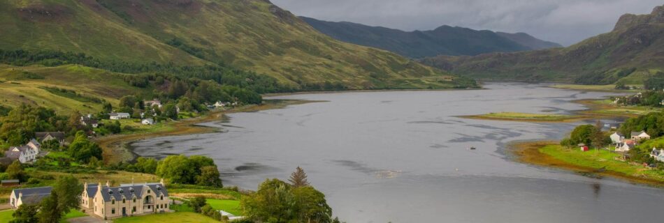 an aerial shot of a river in scotland