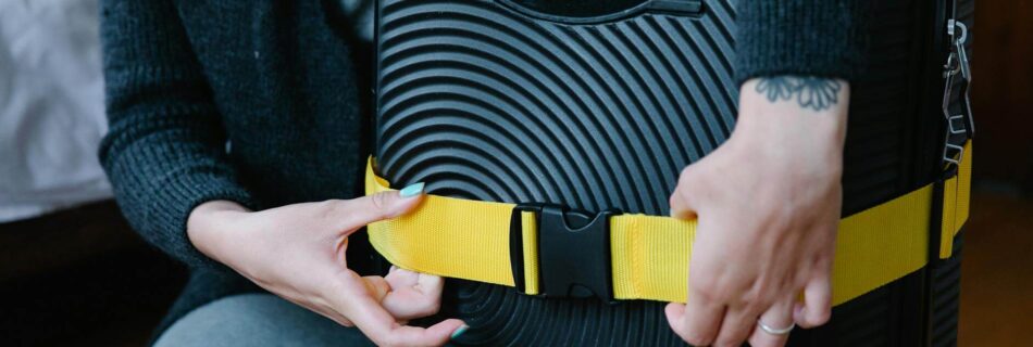 a person checking the strap on luggage